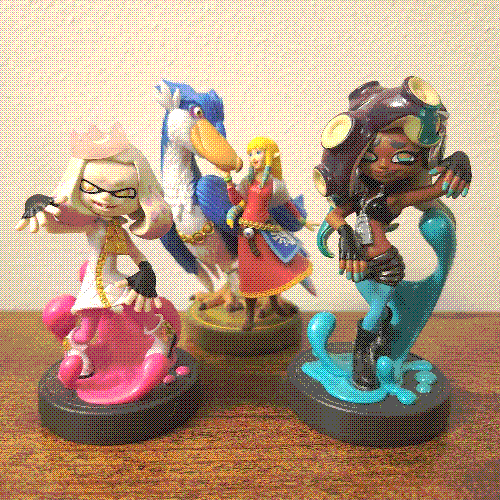 three nintendo amiibo figures.