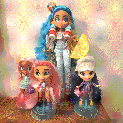 photograph of a shelf of four hairdorables dolls