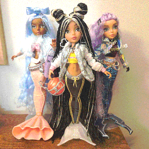 photograph of a shelf of three mermaze dolls