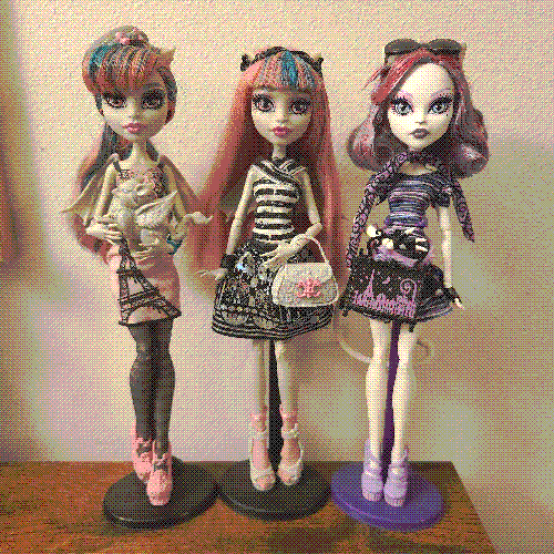 photograph of a shelf of three monster high dolls