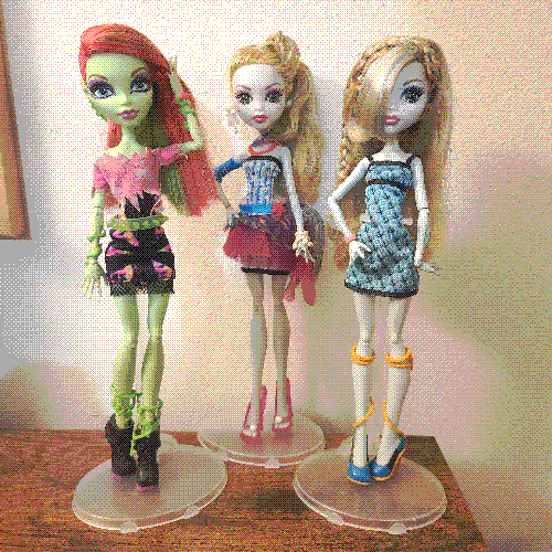 photograph of a shelf of three monster high dolls