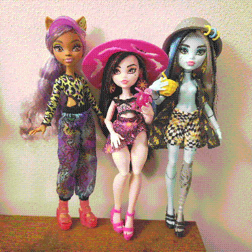 photograph of a shelf of three monster high dolls