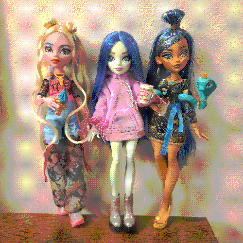 photograph of a shelf of three monster high dolls