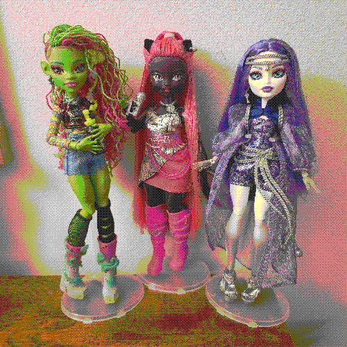 photograph of a shelf of three monster high dolls