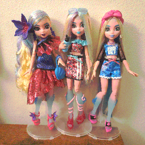 photograph of a shelf of three monster high dolls