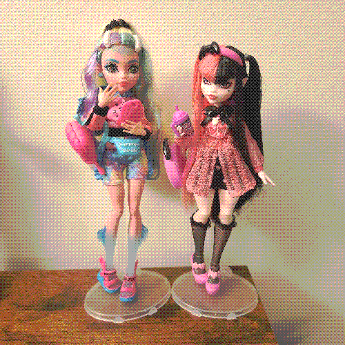 photograph of a shelf of three monster high dolls