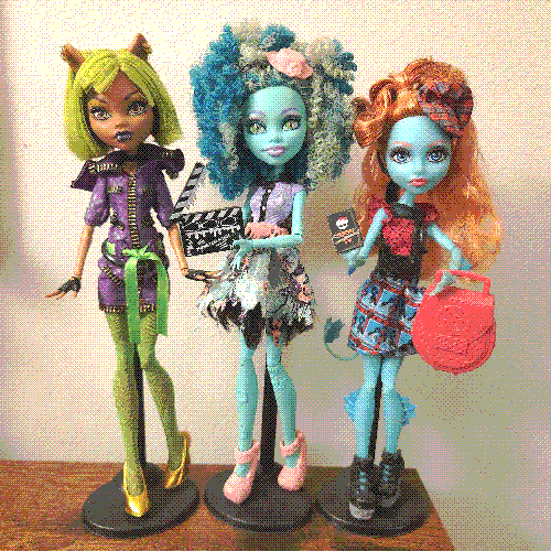 photograph of a shelf of three monster high dolls