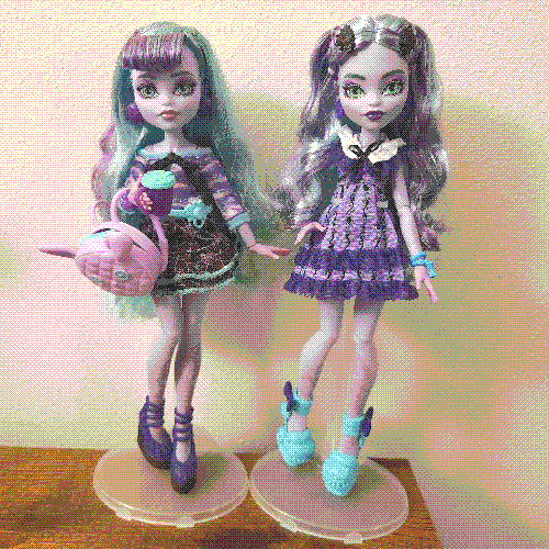 photograph of a shelf of three monster high dolls