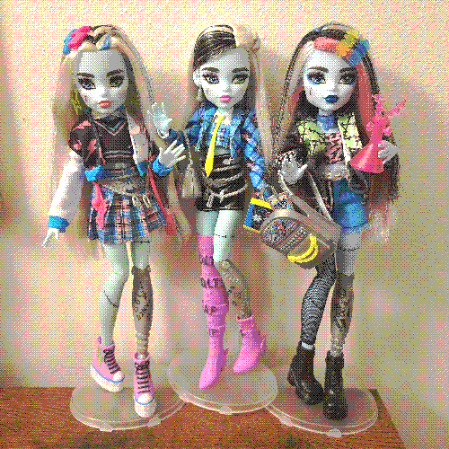 photograph of a shelf of three monster high dolls