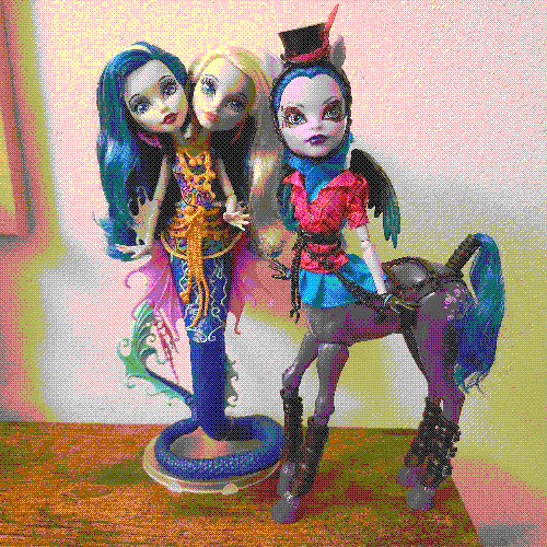 photograph of a shelf of three monster high dolls