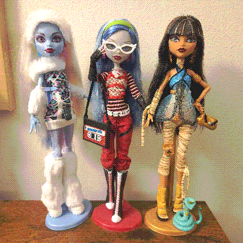 photograph of a shelf of three monster high dolls