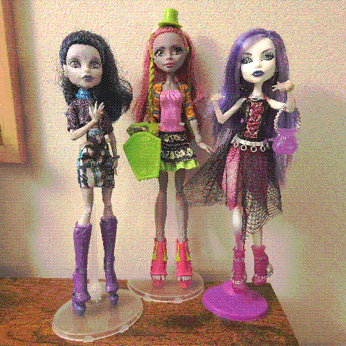 photograph of a shelf of three monster high dolls