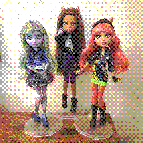 photograph of a shelf of three monster high dolls