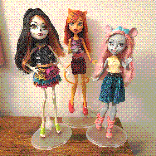 photograph of a shelf of three monster high dolls