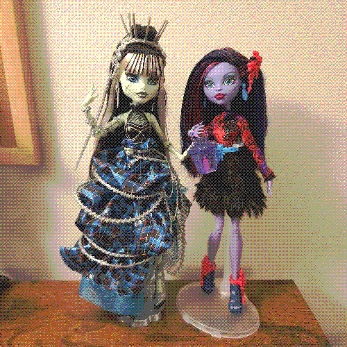 photograph of a shelf of three monster high dolls