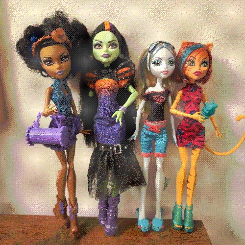 photograph of a shelf of three monster high dolls