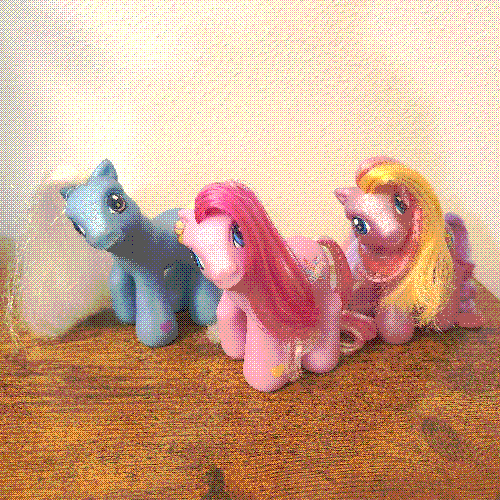 photograph of a shelf of many my little pony figures