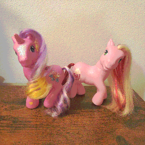 photograph of a shelf of many my little pony figures