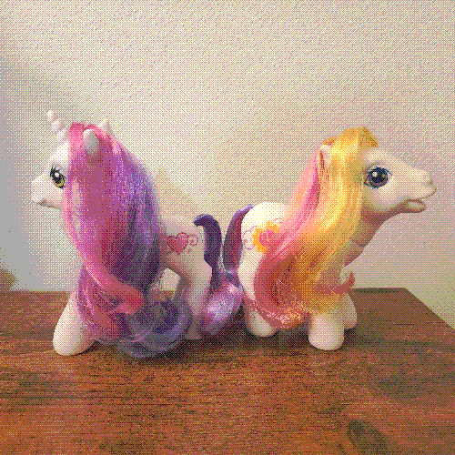 photograph of a shelf of many my little pony figures