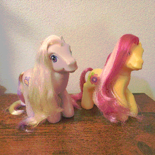 photograph of a shelf of many my little pony figures