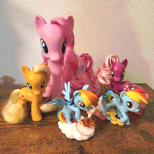 photograph of a shelf of many my little pony figures