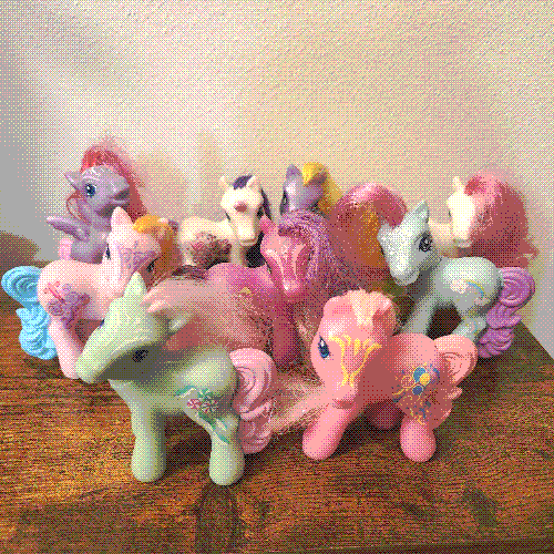 photograph of a shelf of many my little pony figures