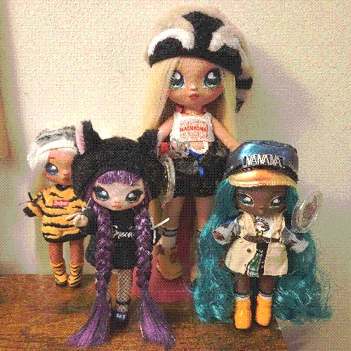 photograph of a shelf of four na na na suprise dolls