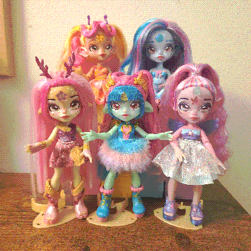 photograph of a shelf of five dolls