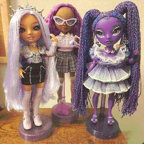 photograph of a shelf of three rainbow high dolls