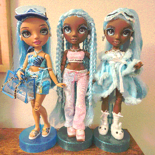 photograph of a shelf of three rainbow high dolls