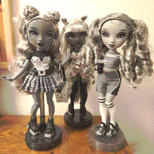 photograph of a shelf of three rainbow high dolls