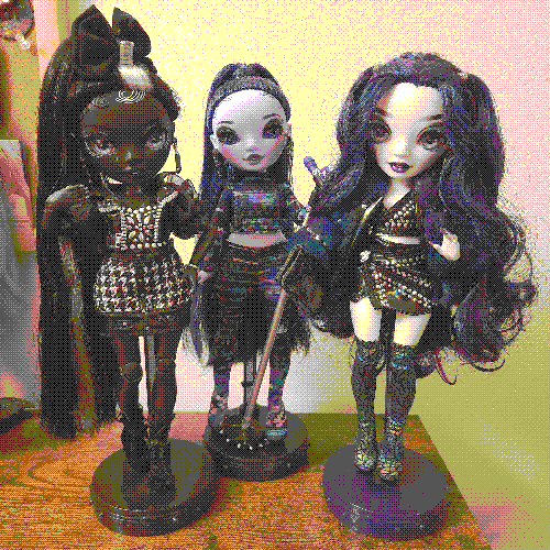 photograph of a shelf of three rainbow high dolls