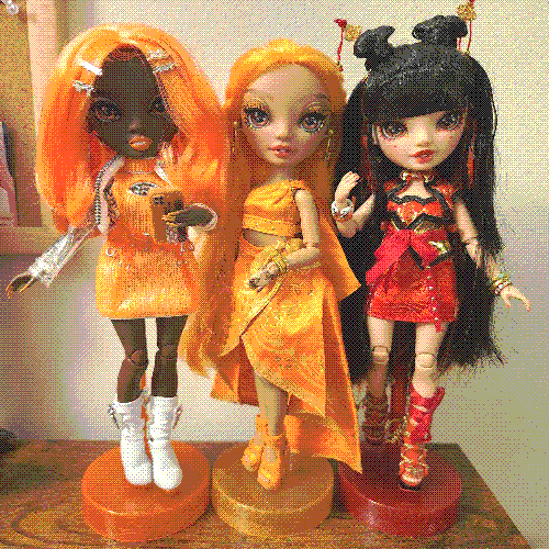 photograph of a shelf of three rainbow high dolls