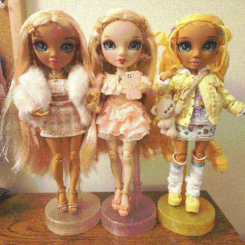 photograph of a shelf of three rainbow high dolls