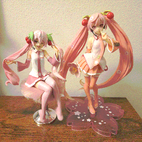 two pink hatsune miku figures.